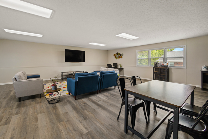 Business center with couches, a tv, and a table