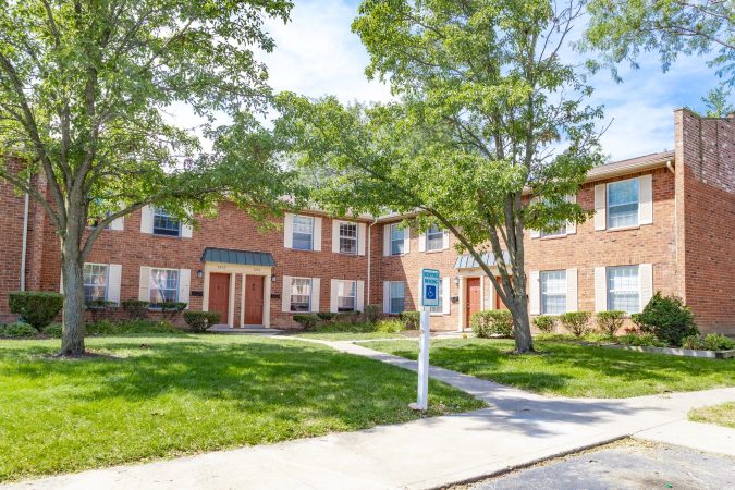 Exterior shot of apartment building with handicap parking sign